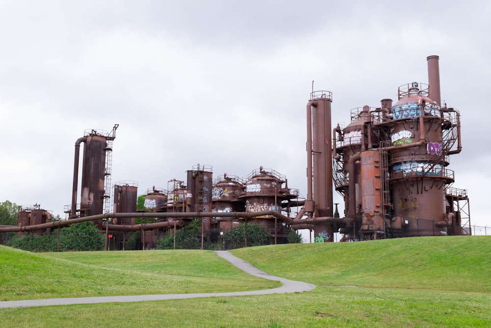 a large factory with a lot of smoke coming out of it with Gas Works Park in the background