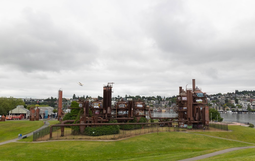 a large factory with smoke stacks with Gas Works Park in the background