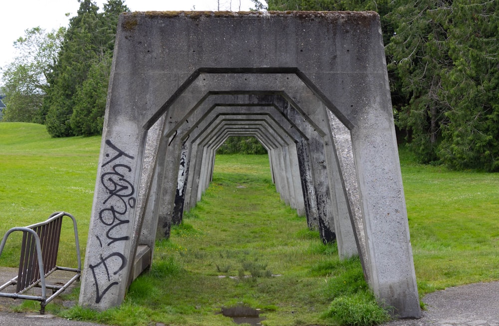 a stone arch with graffiti