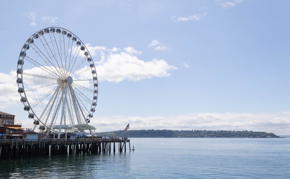 a ferris wheel by a body of water