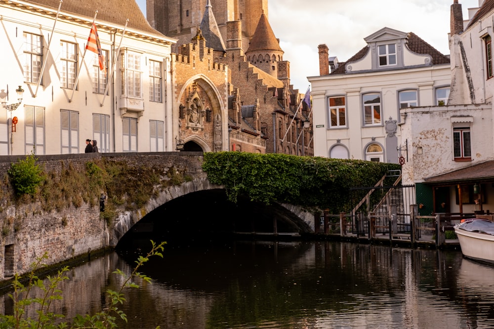 a bridge over a river between buildings