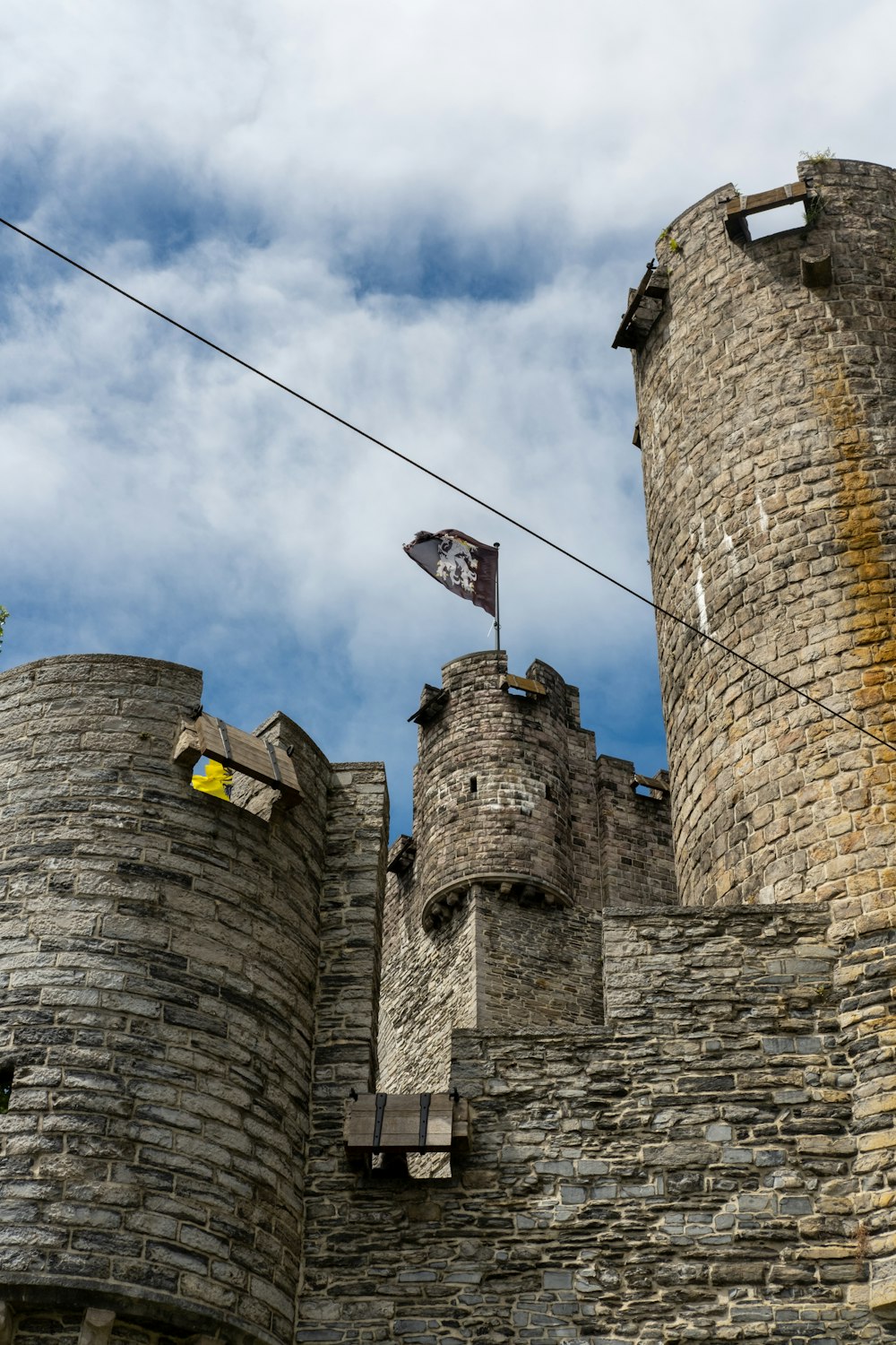 a stone castle with a flag on top