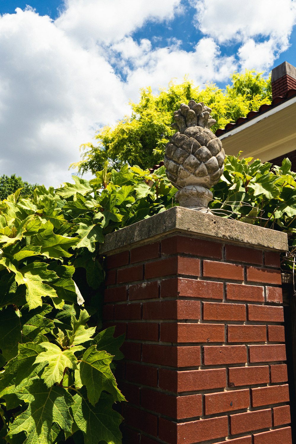 a brick chimney with a tree growing on top