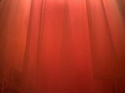 Burnt orange fabric folds capturing Tuesday's warm, energetic vibe.