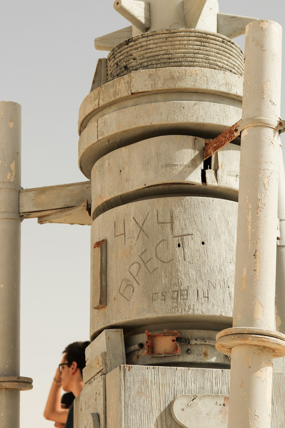 a person standing next to a large metal structure