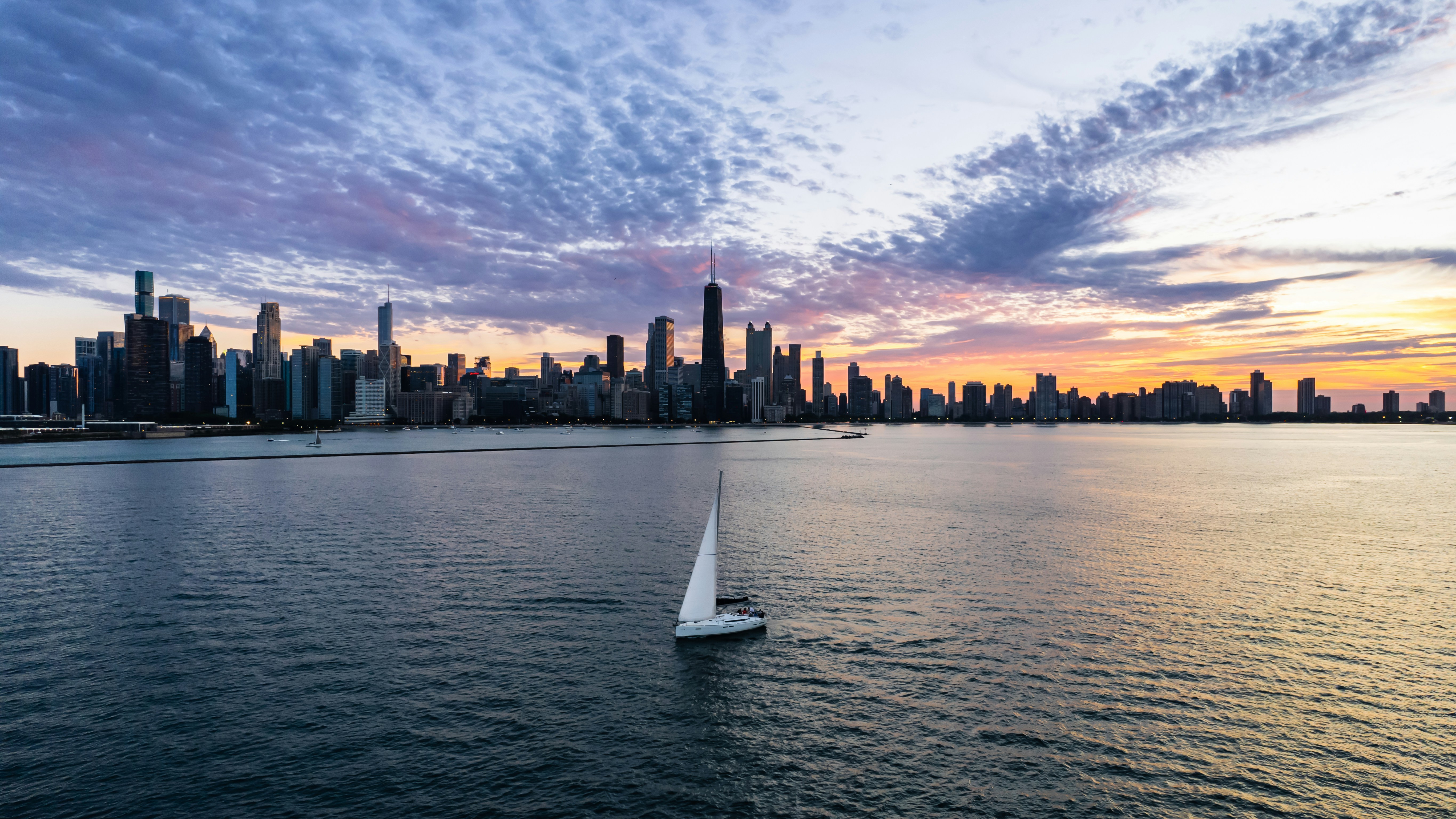 Chicago skyline from the water, with text overlay "Federal, State, and City Rules" - are bareboat charters legal in chicago