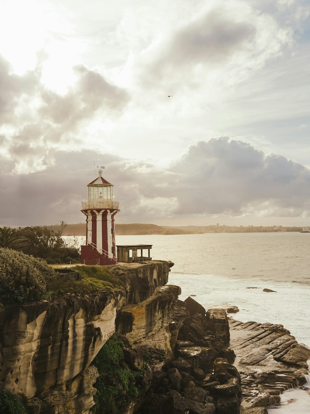 a lighthouse on a rocky cliff