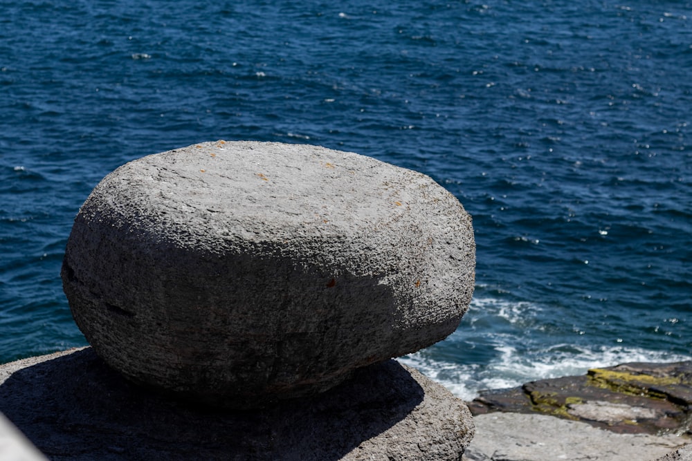 a rock on a rock by the water