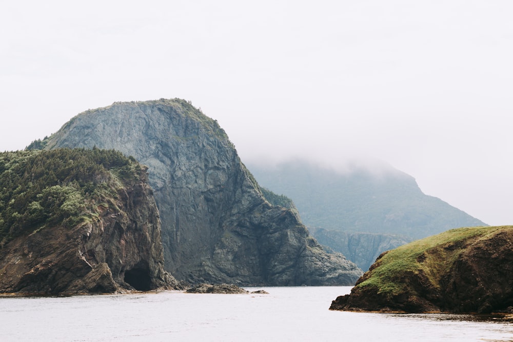 a body of water with hills and trees around it