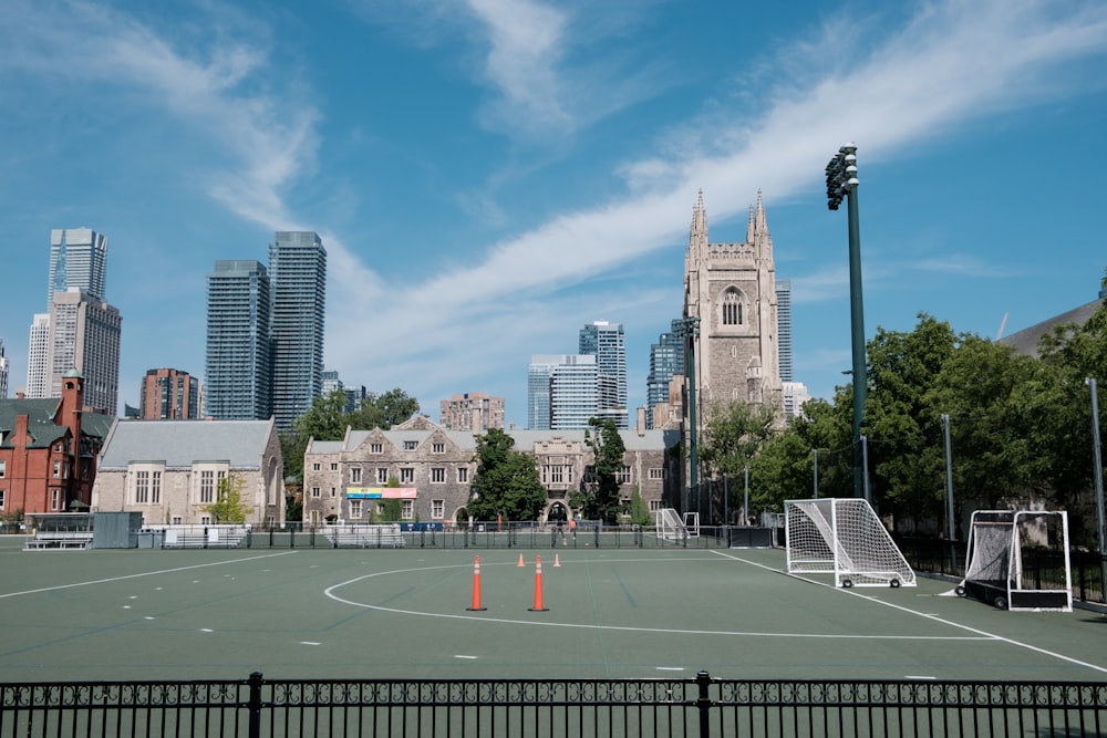 a tennis court with a city in the background