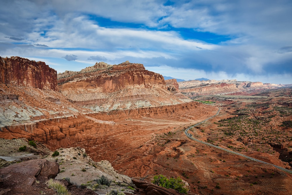 a road in a desert with Capitol Reef National Park in the background