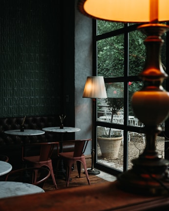 Interior view of Cafe Capsule LLC showing sleek capsule seating and warm lighting.