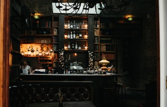 A cozy vintage library corner with a classic speakeasy vibe, featuring old books, cocktail glasses, and warm amber lighting.