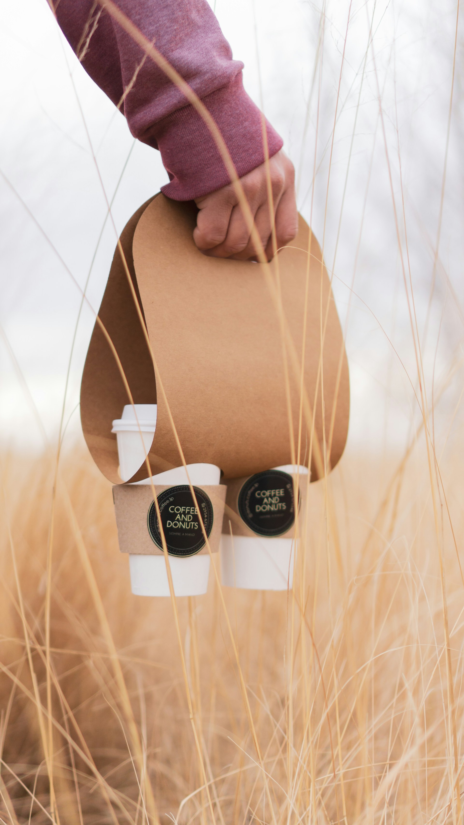 a person holding a bag of coffee beans