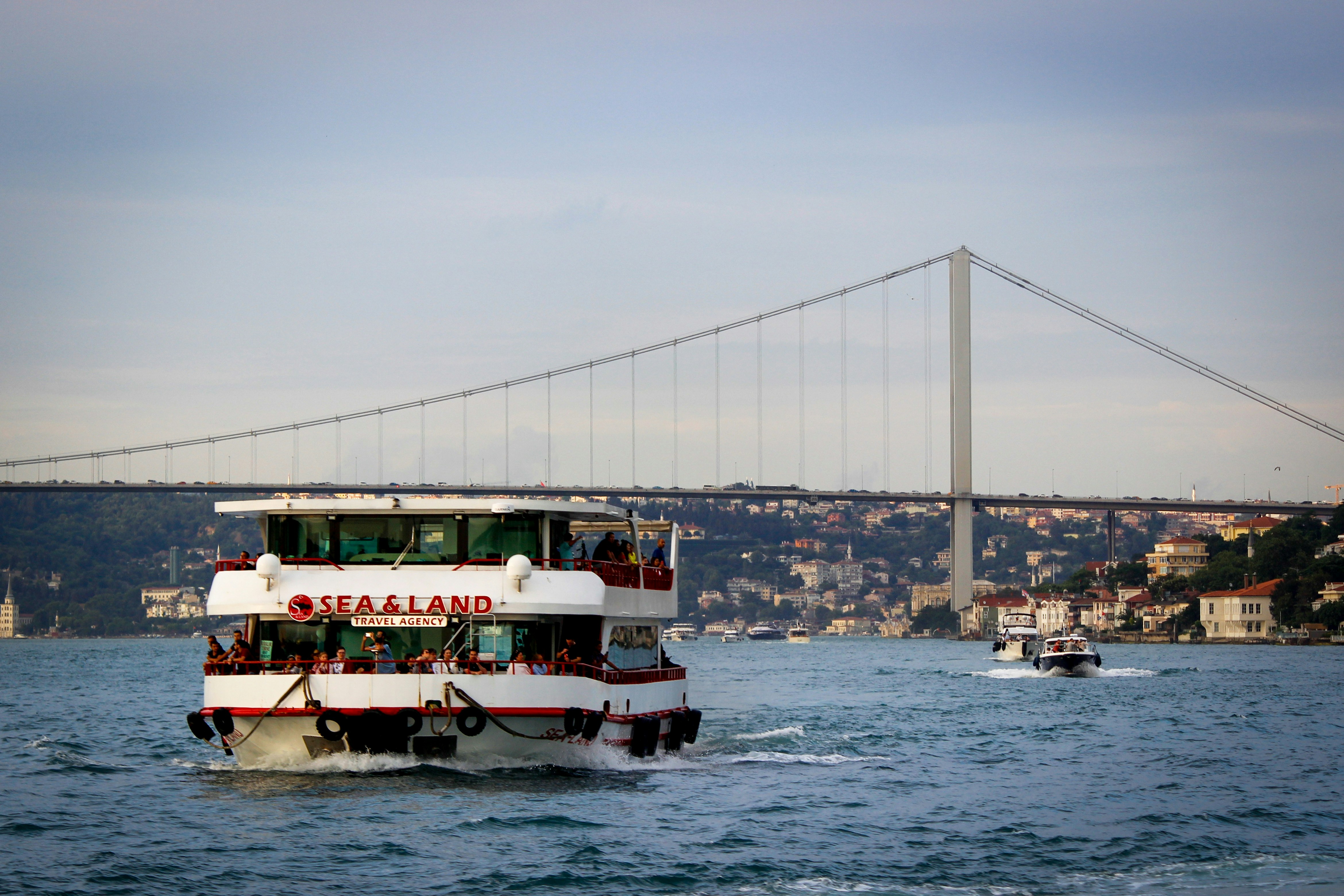 a boat sailing under a bridge