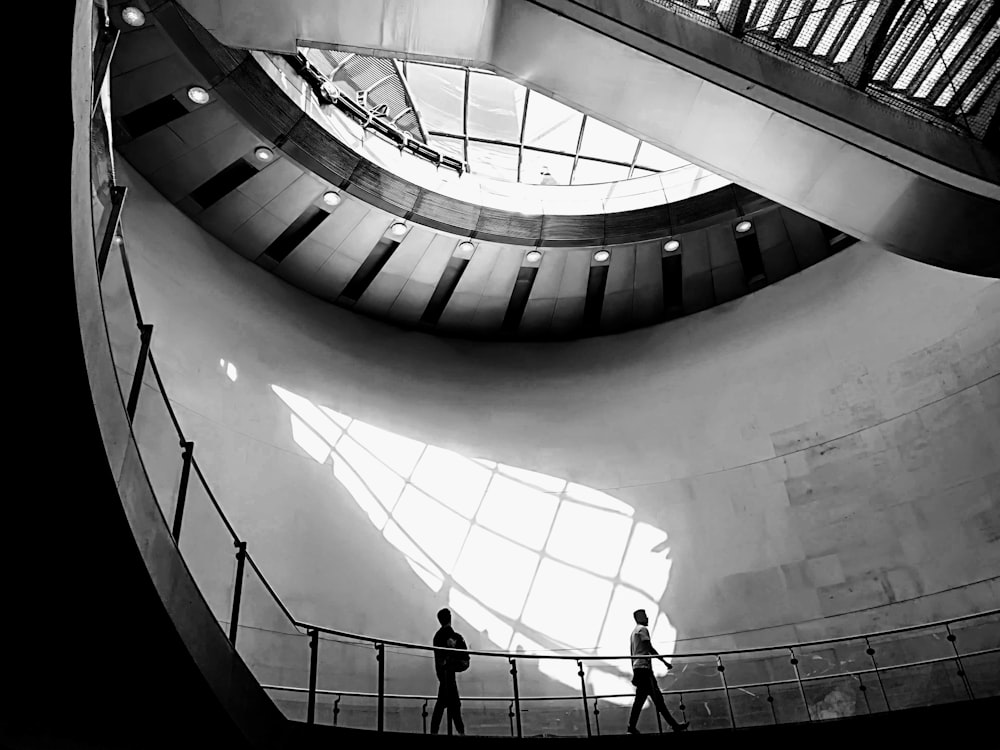 a couple of people standing in a large building