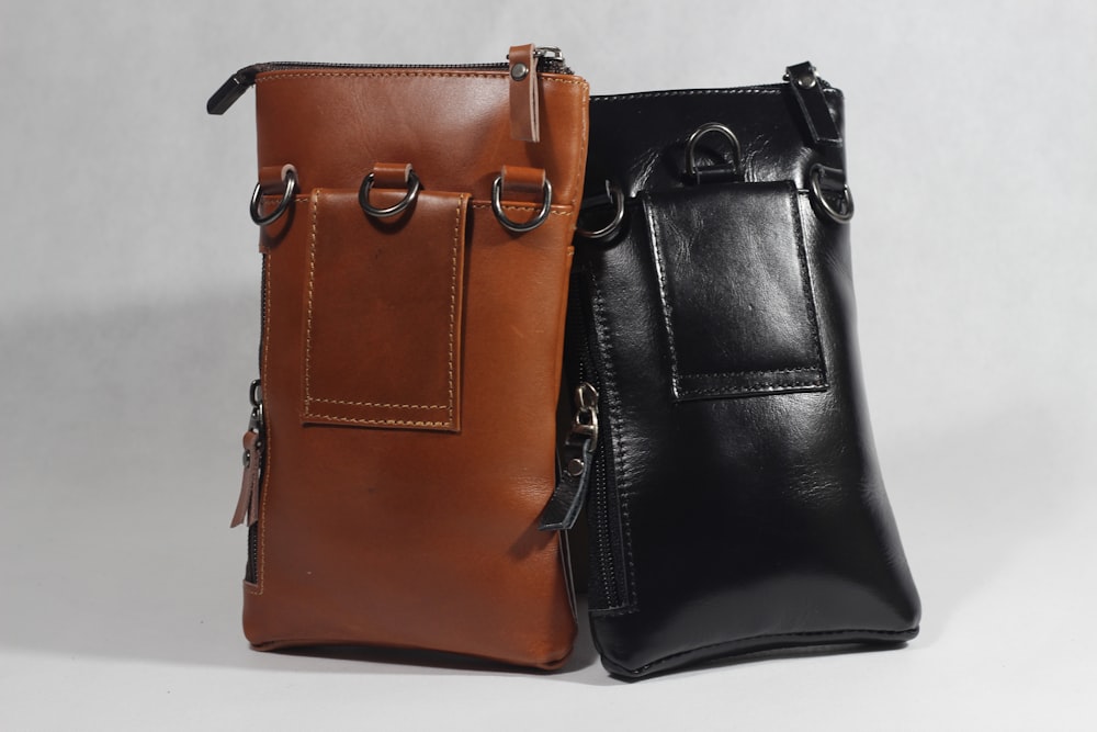 a pair of brown leather handbags