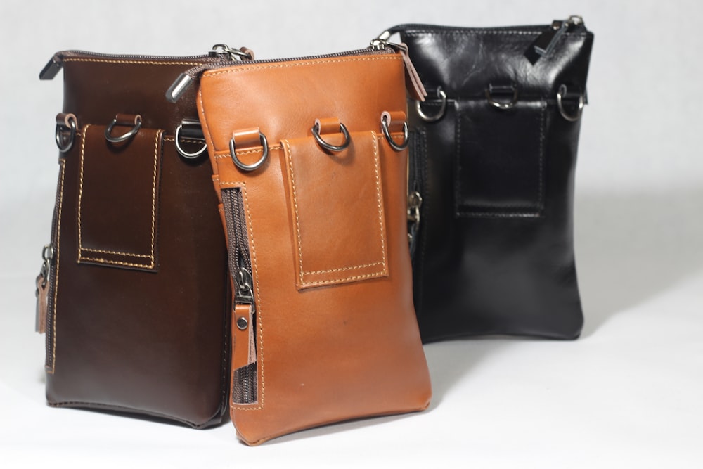 a couple of brown leather bags