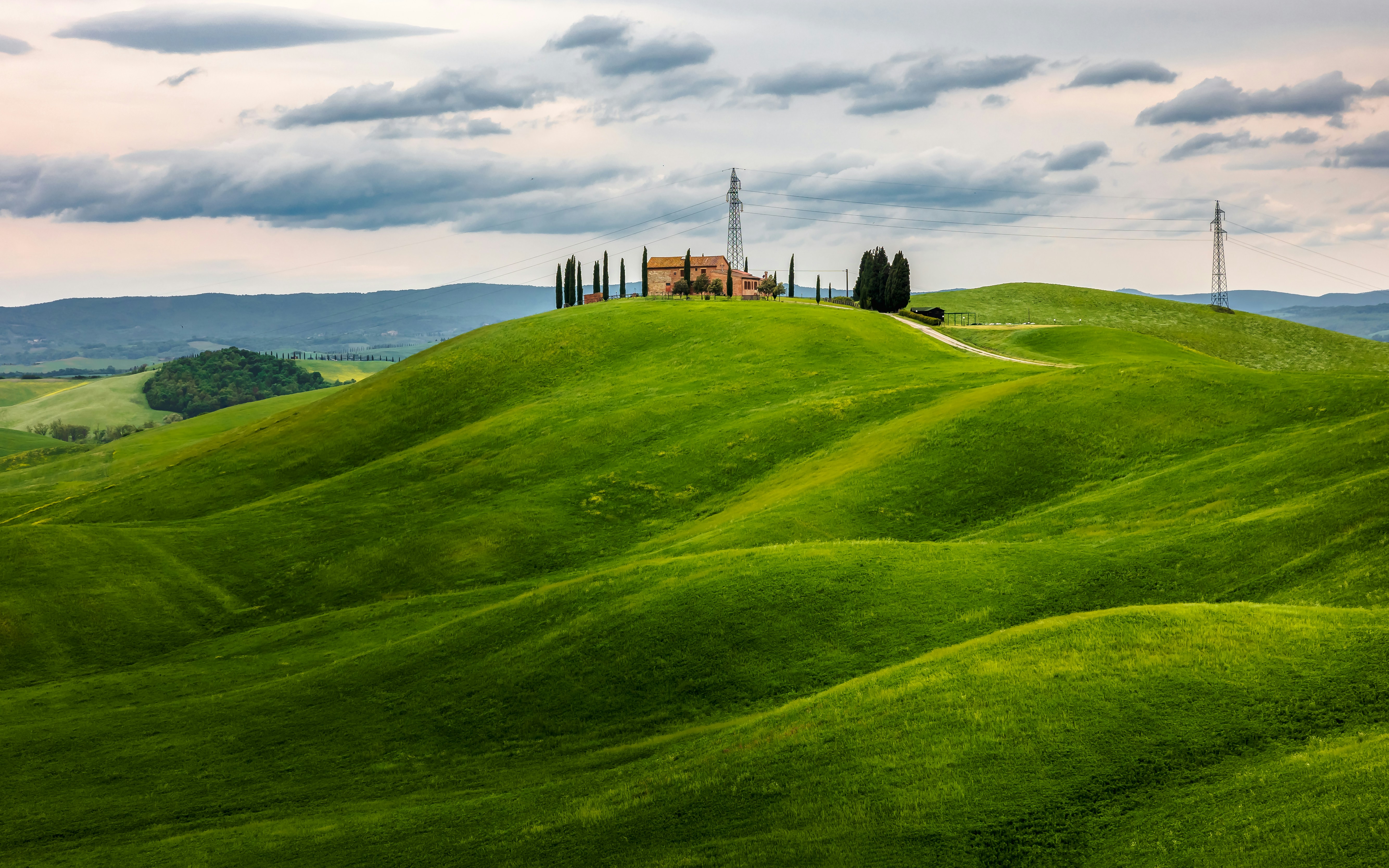 A green field with a building in the distance