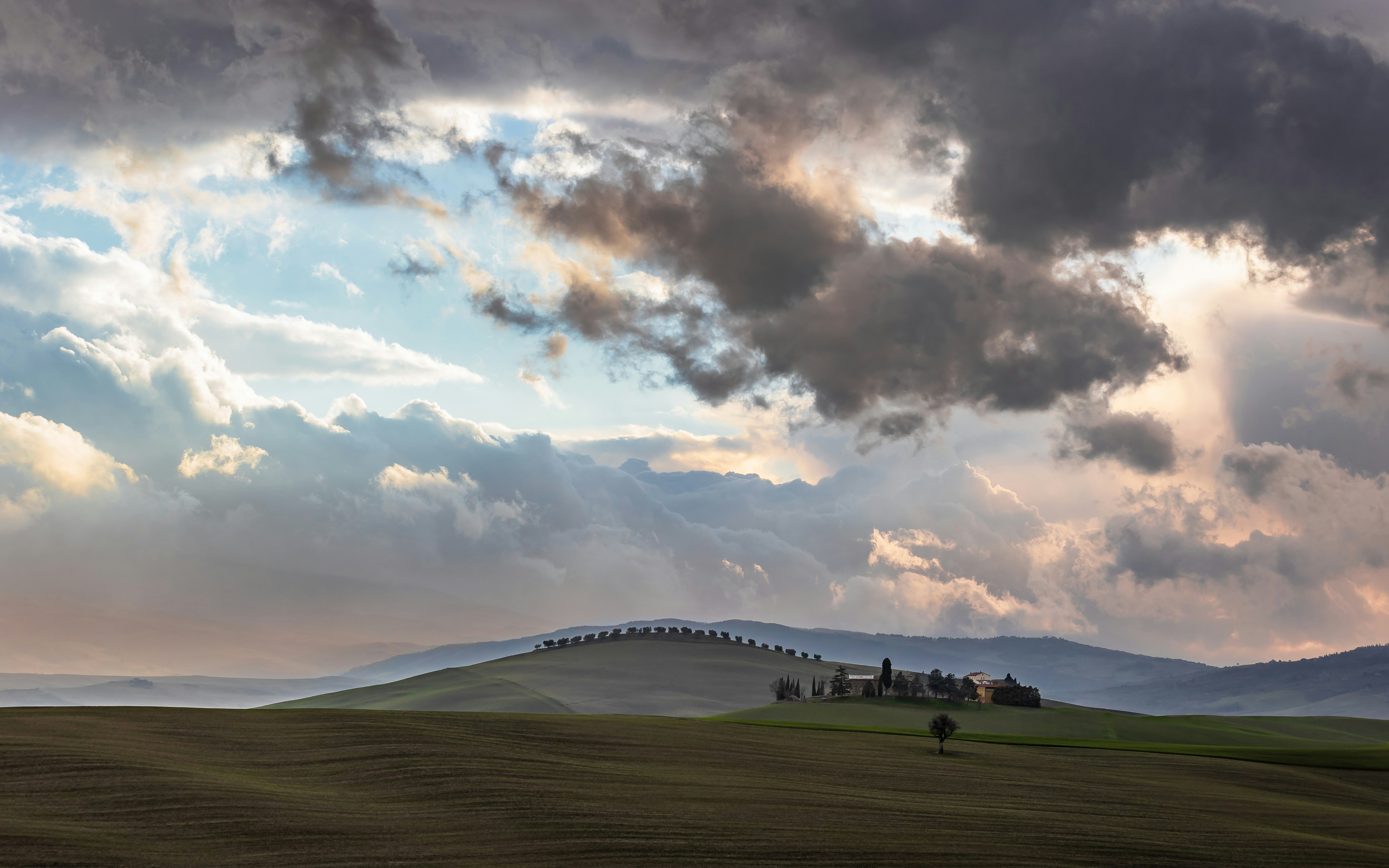 A large field with a bridge in the distance