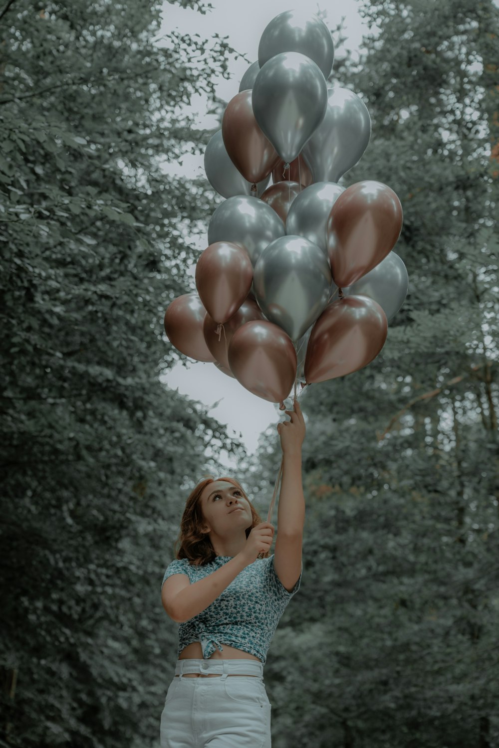 a person holding a bunch of balloons