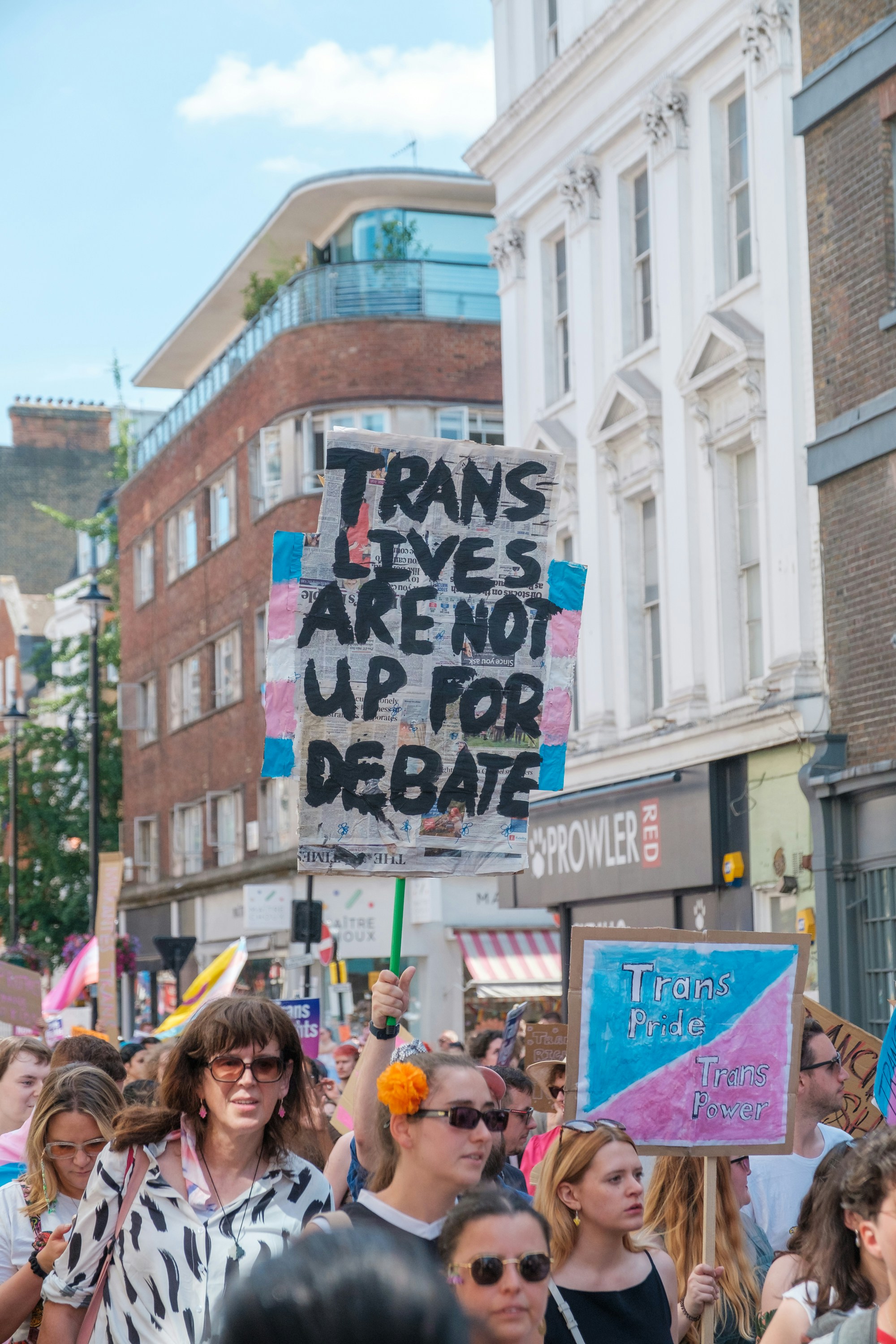 A group of people holding signs photo – Free London Image on Unsplash