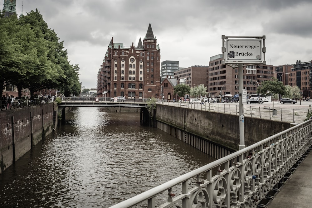 a river with a bridge and buildings