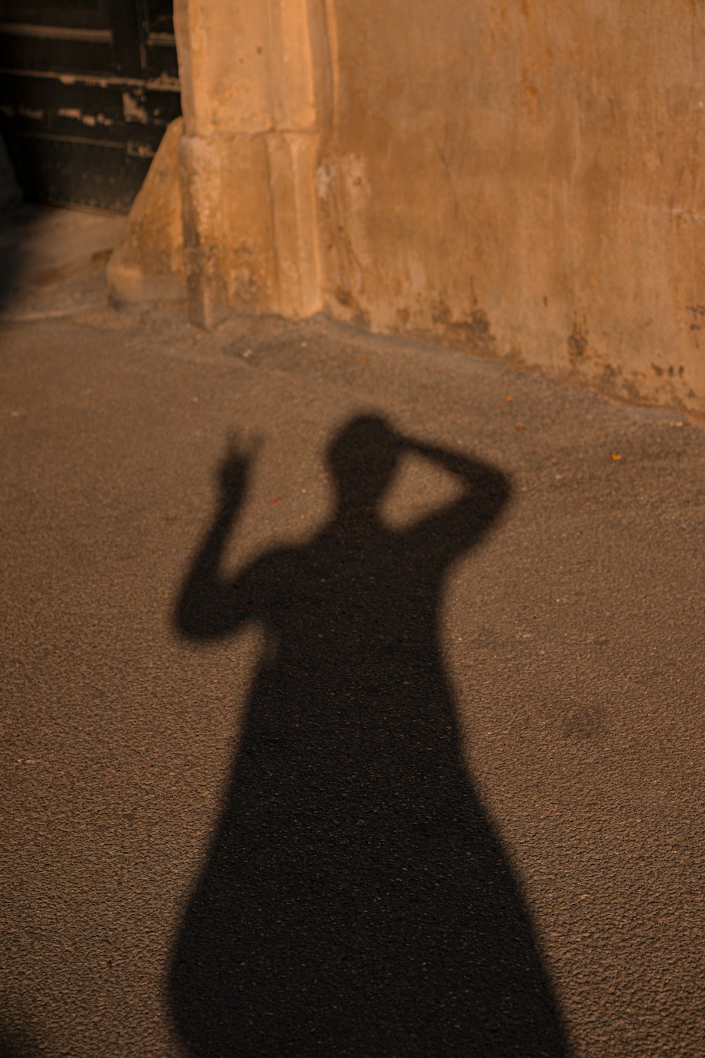 a shadow of a person on the ground