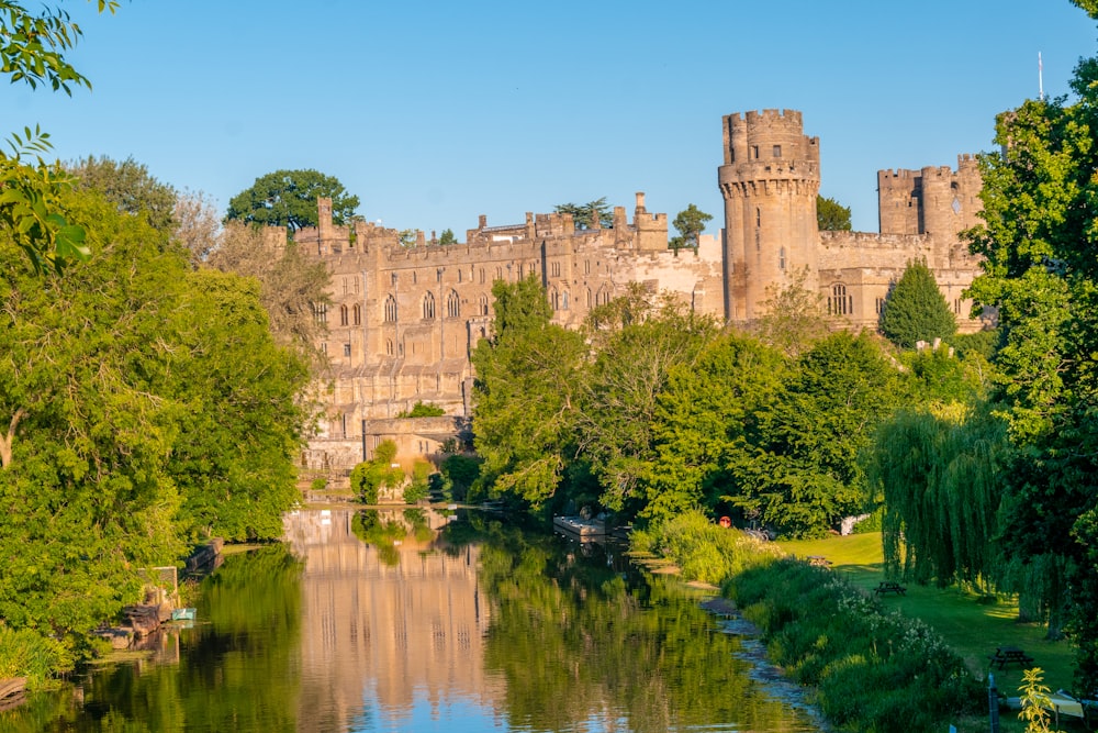 a castle on a hill with Warwick Castle in the background