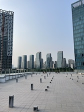 Modern architectural blueprint spread out on a sleek desk with a city skyline in the background.
