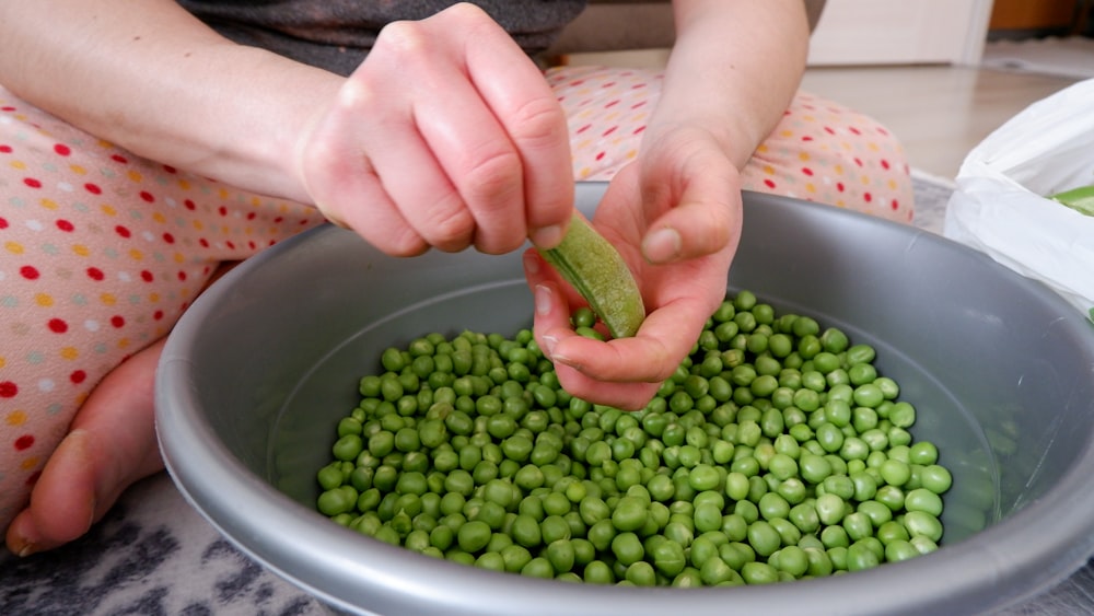 a person holding a vegetable