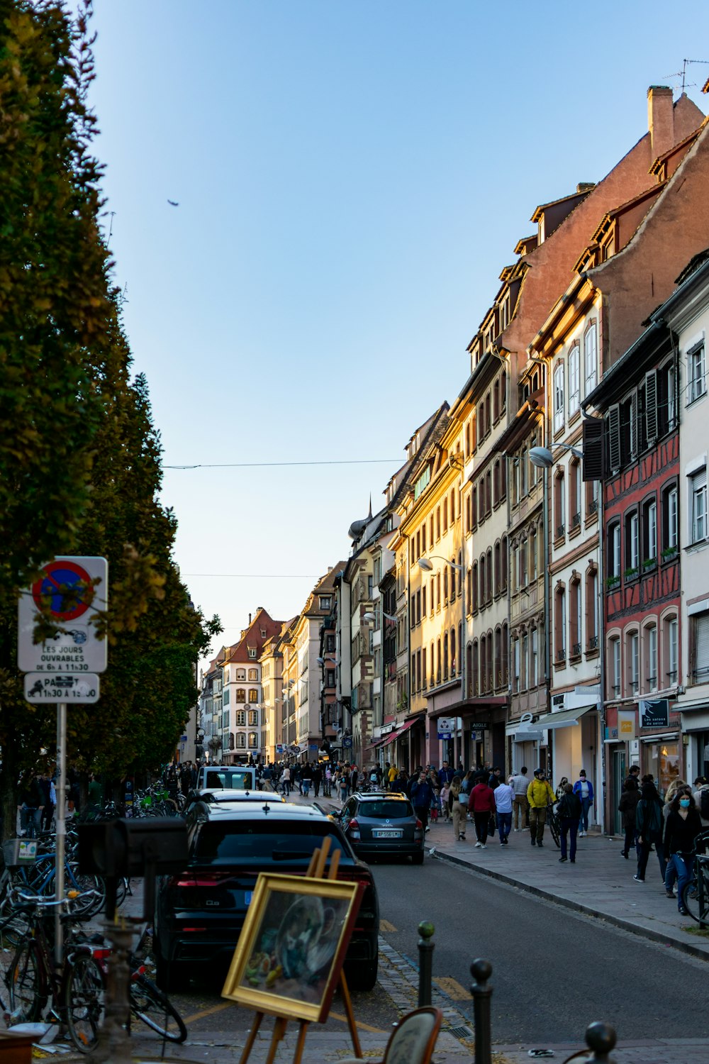 a busy street with cars and people