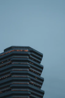 Architectural skyscraper model with sharp titanium gray tones and neon blue highlights in a negative space layout