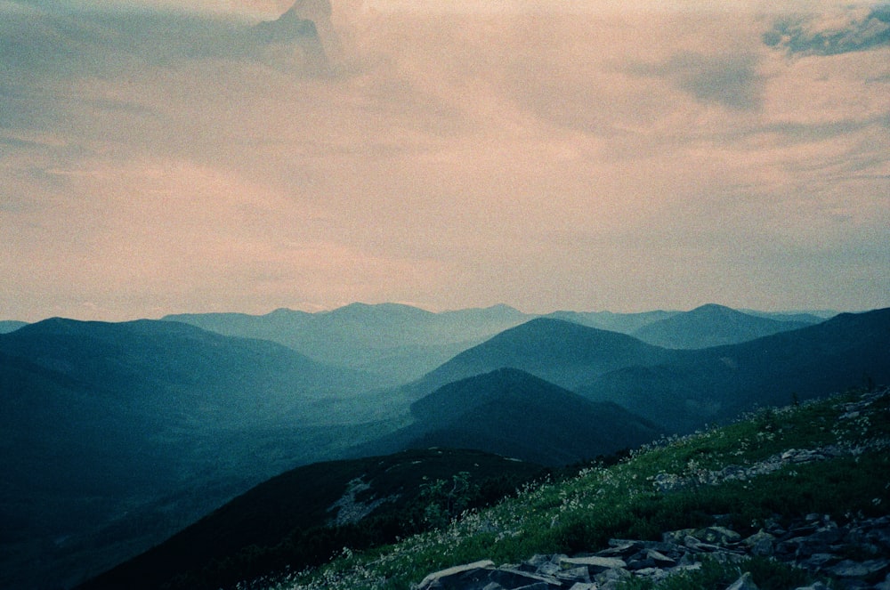 a landscape with hills and a body of water in the distance