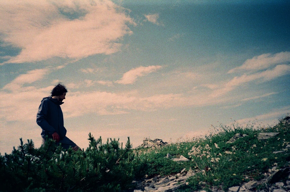 a man sitting on a hill