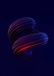 A twisting, abstract 3D shape with smooth, flowing curves and a glossy surface. The object features a combination of deep blue and red lighting effects, creating a dynamic and futuristic appearance against a dark background.