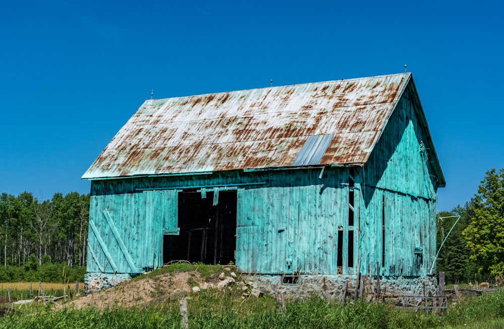 a blue barn with a roof