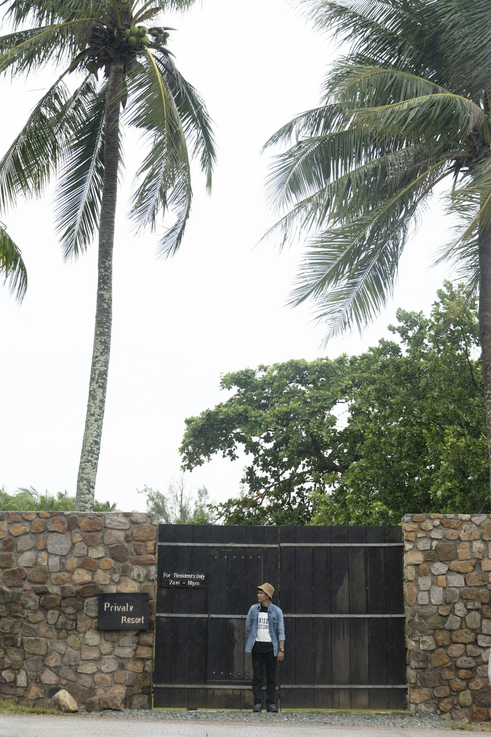 a person standing next to a fence