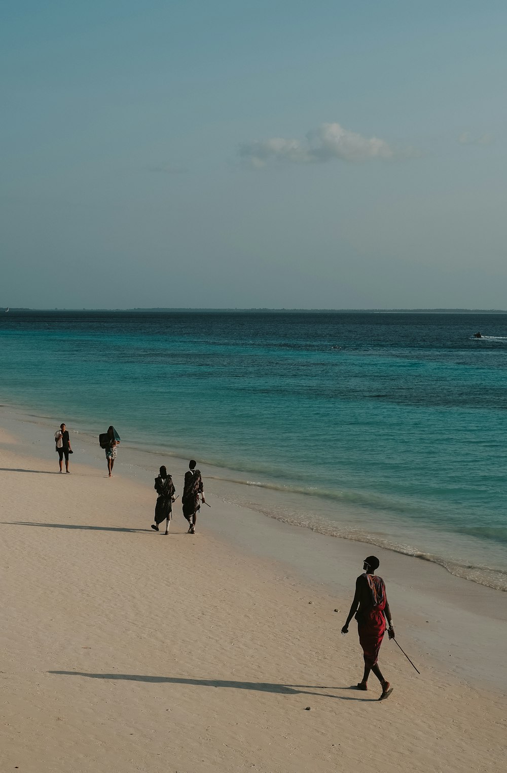 people walking on a beach