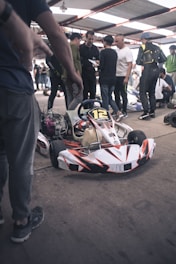 Groups of amateur kart racers cheering on the podium after a thrilling race.