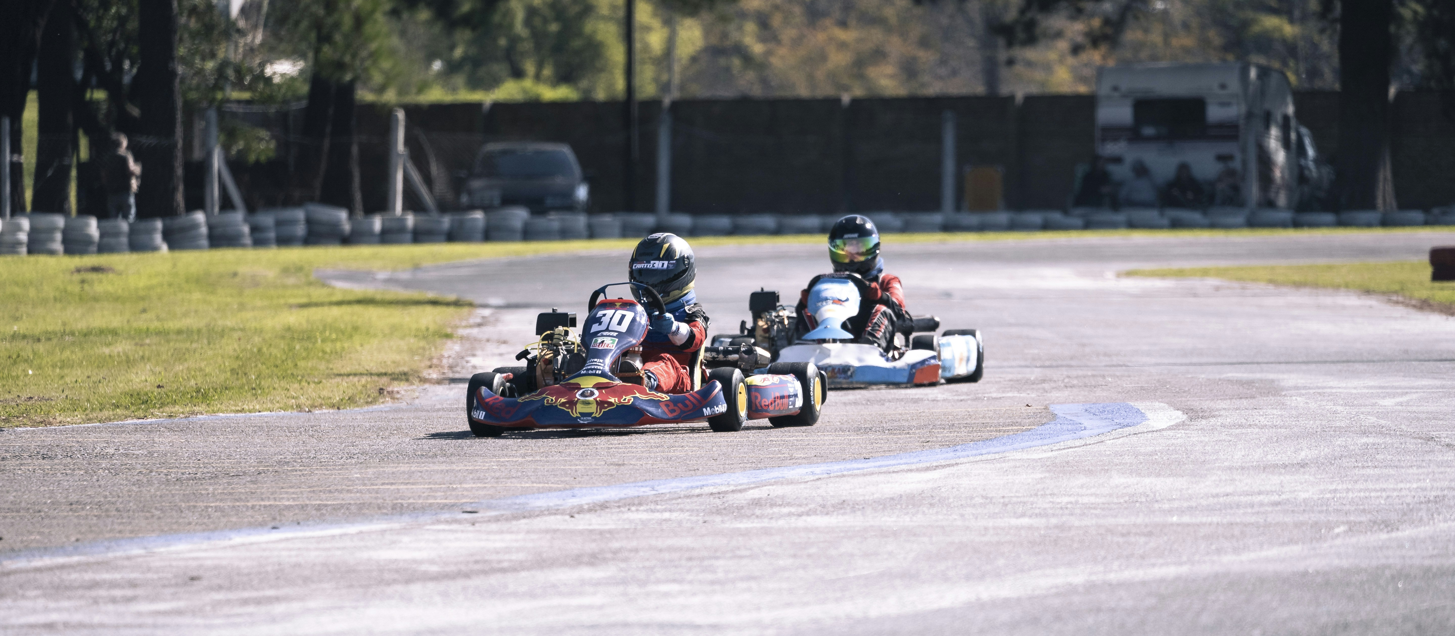 a group of people racing go karts on a track