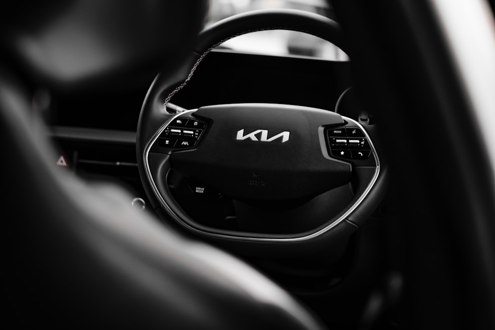 a black and white photo of a car steering wheel