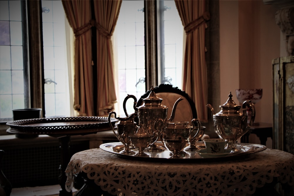 a table with teapots and tea cups on it