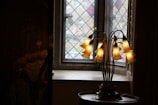 A beautifully restored Tiffany-style lamp glowing warmly in a cozy living room.