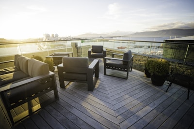 An inviting outdoor seating area with ocean views and sunset lighting.