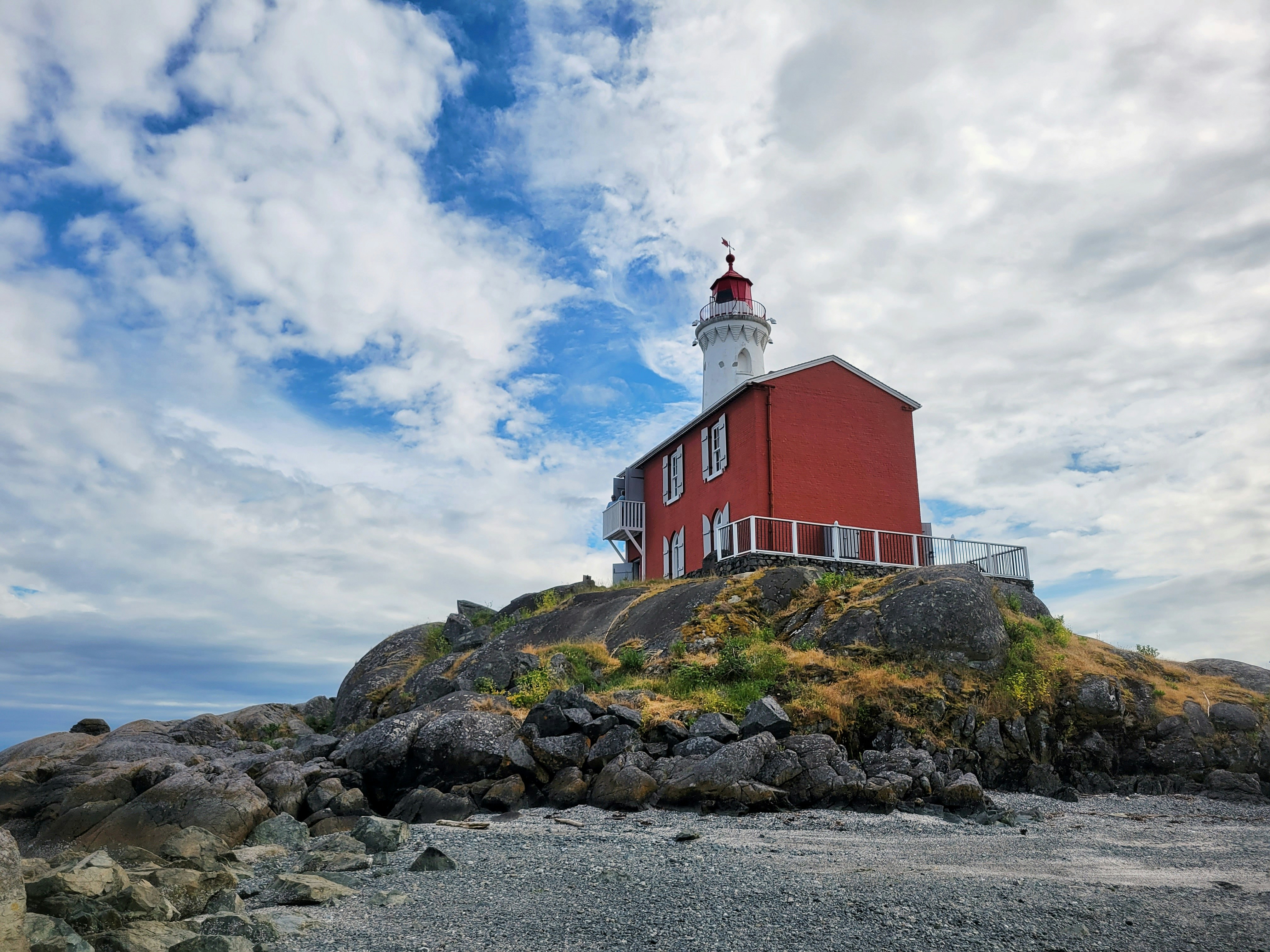 a lighthouse on a rocky hill