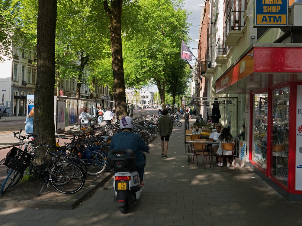 a person riding a scooter down a sidewalk