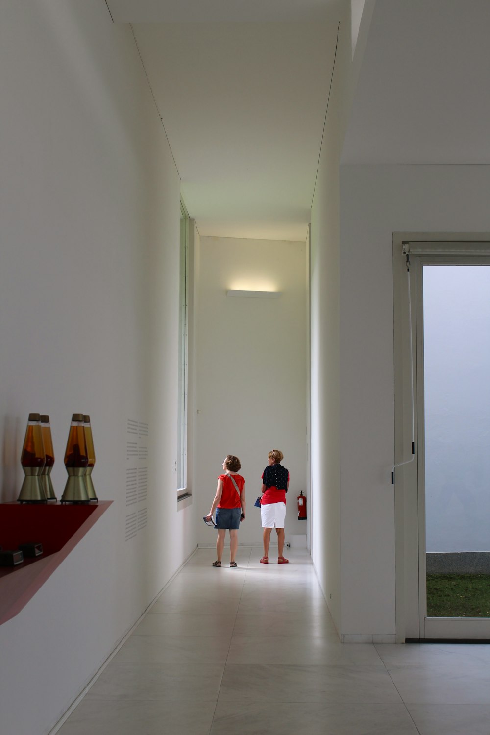 a couple of women standing in a hallway