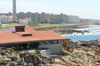 a building on a rocky beach