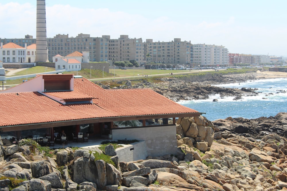 a building on a rocky beach